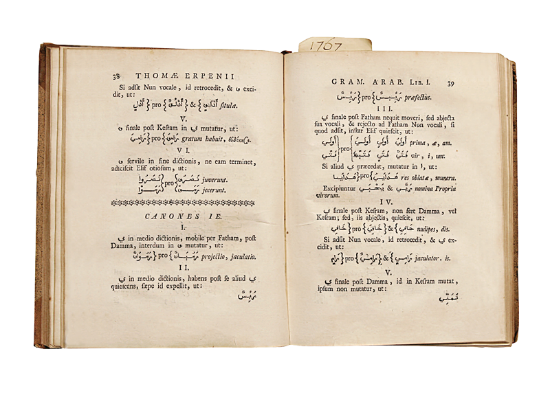 Two open book pages filled with Arabic and Latin text